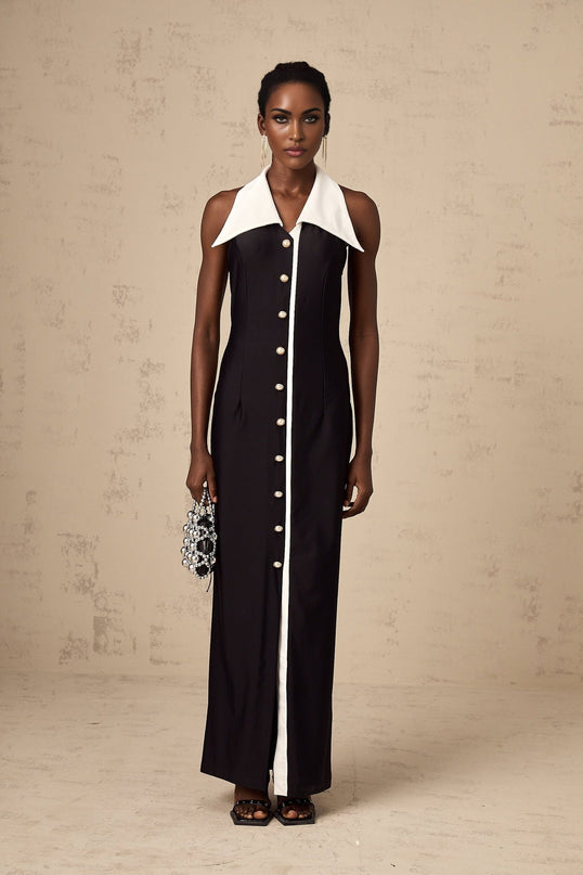 Woman wearing a long fitted maxi dress with colorblocked design in contrasting colors