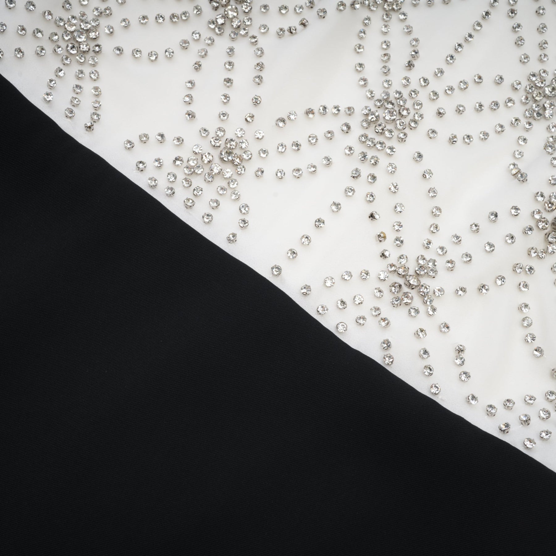 Woman wearing a long flowing embellished dress with intricate detailing and a feminine silhouette