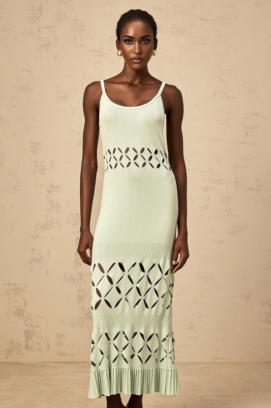 Woman wearing a long green knitted maxi dress with cutout details