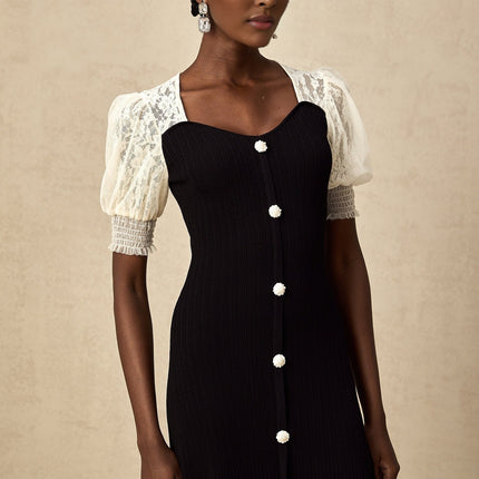 Woman wearing a long knit midi dress with lace trim details and a fitted silhouette in a neutral color