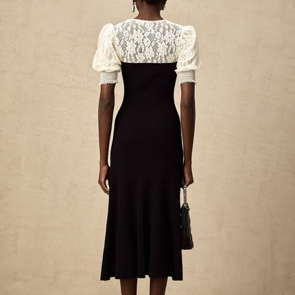 Woman wearing a long knit midi dress with lace trim details