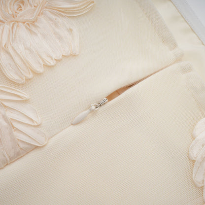 Woman wearing a long offshoulder maxi dress in neutral colors with embroidered details