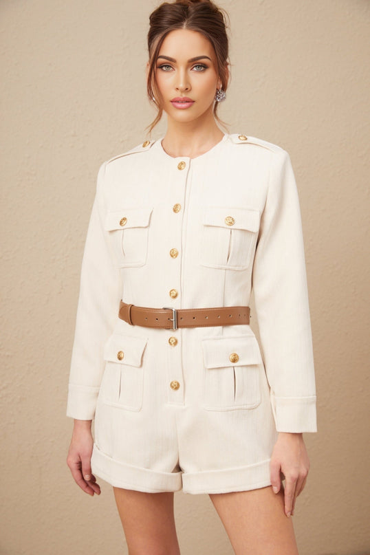 Woman wearing a long sleeve tweed bodysuit in neutral tones standing against a plain background