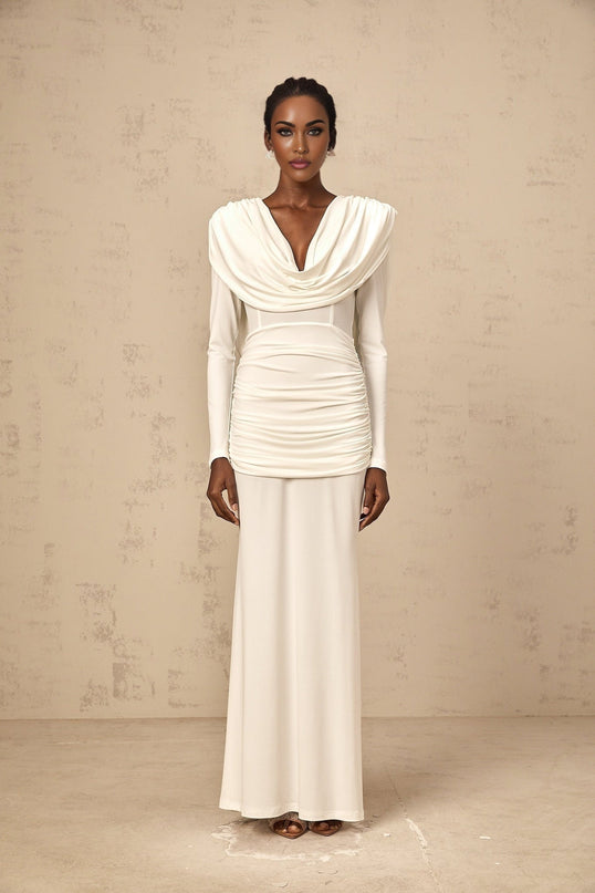 Woman wearing a long white fitted maxi dress with ruched detailing