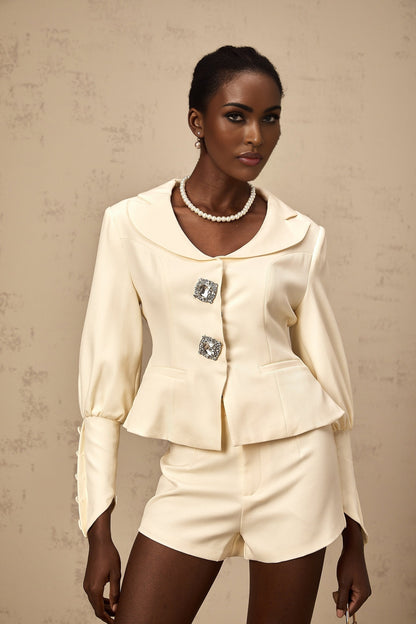 Woman wearing a matching crystalembellished jacket and shorts set in Iselin style