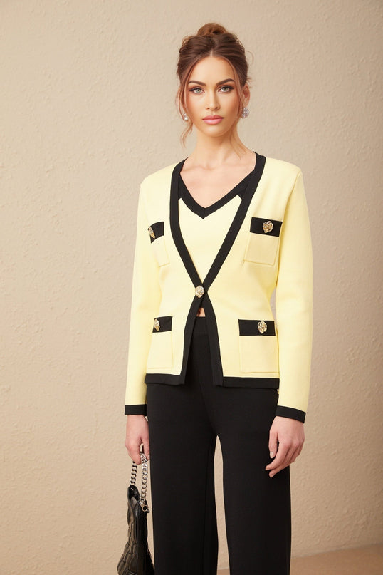 Woman wearing a matching knit cardigan vest and trousers set with contrasting trim called Eloise