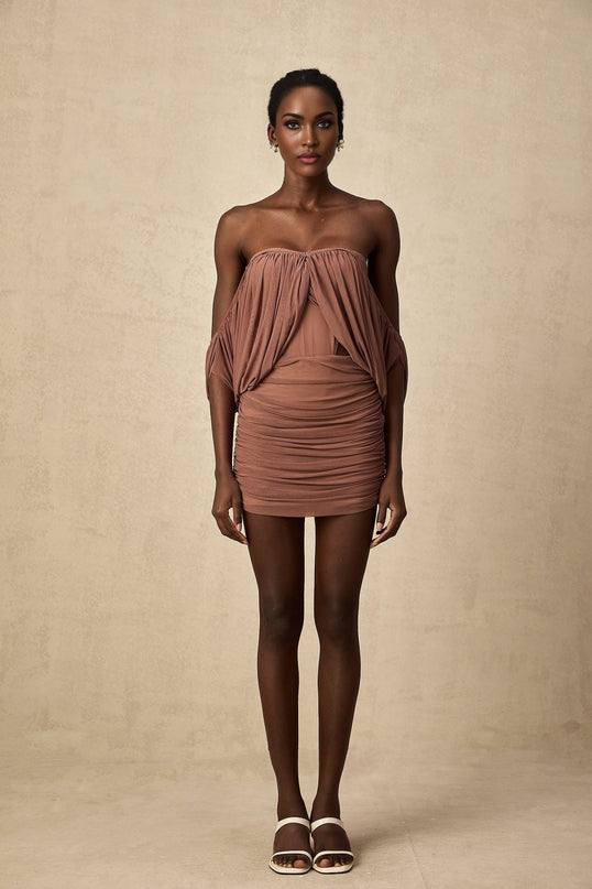 Woman wearing a matching offshoulder bodysuit and skirt set in a light color