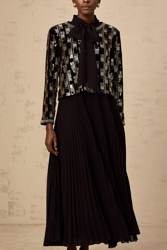 Woman wearing a matching sequined cardigan and dress set in a checkered pattern named Eva