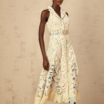 Woman wearing a midi length dress with floral embroidery and cutout details