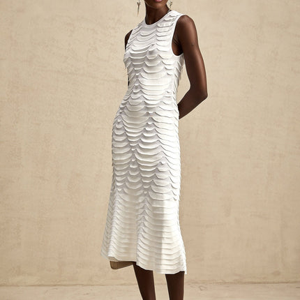 Woman wearing a midi length dress with snake pattern print and godet skirt design