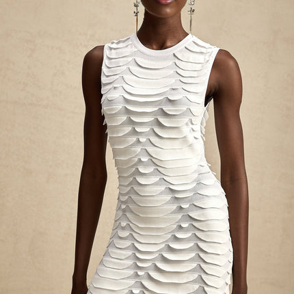 Woman wearing a midi length dress with snake pattern print and godet skirt design