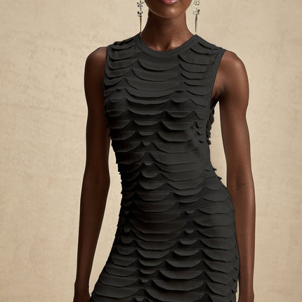 Woman wearing a midi length dress with snake pattern print and godet skirt details