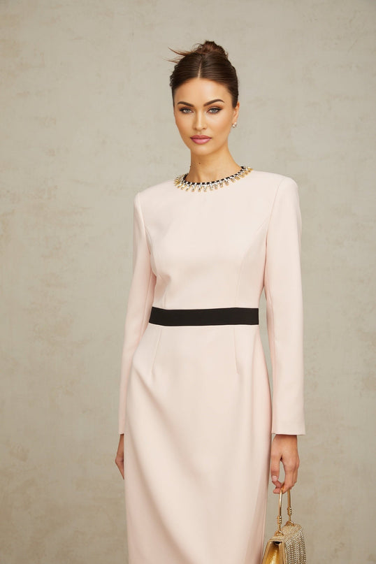 Woman wearing a pink crystal colorblocked midi dress with a fitted silhouette and contrasting panels