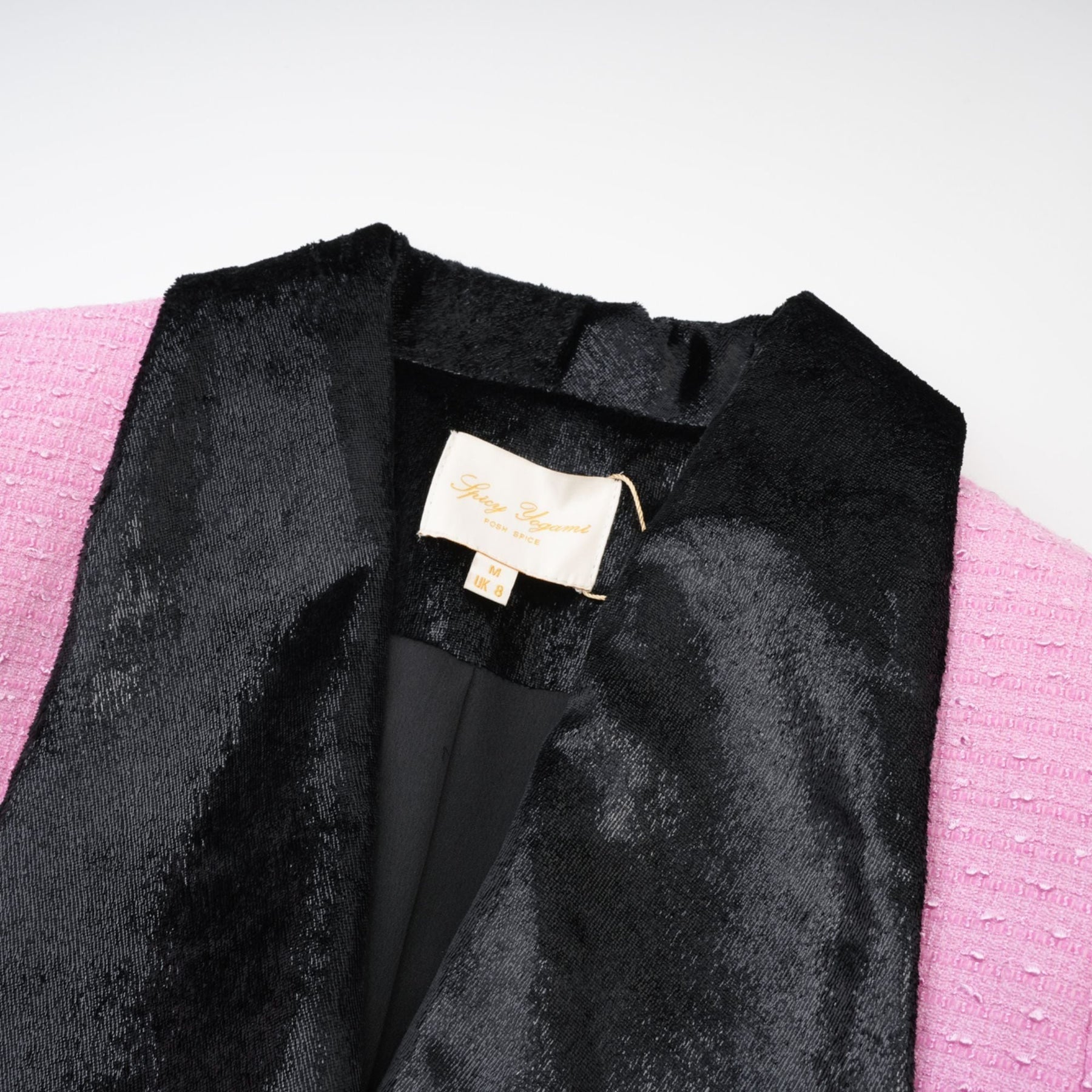 Pink dress with Vshaped collar fulllength sleeves front button closures and fitted waist design