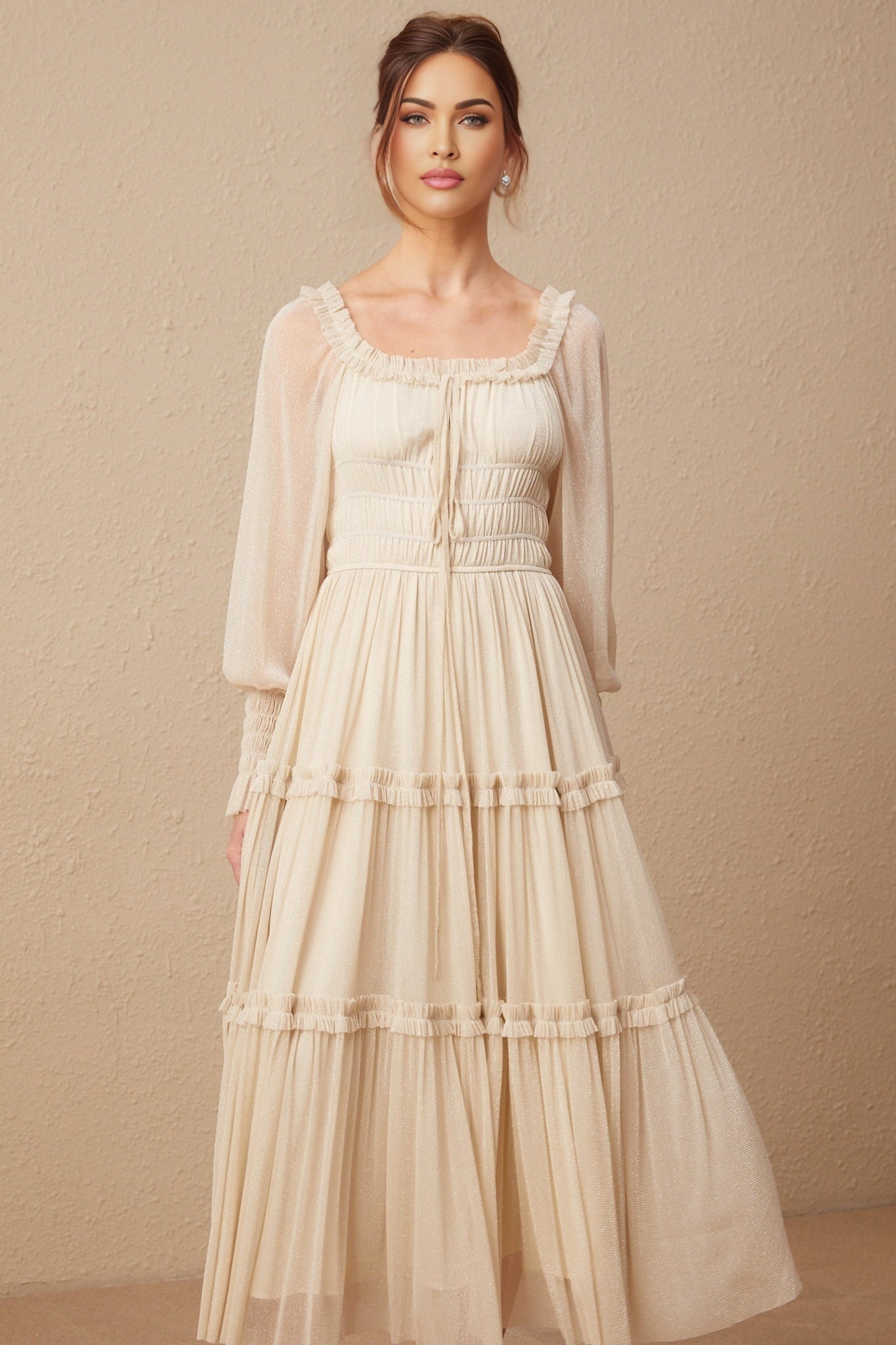 Woman wearing a pleated metallic midi dress with shirred detailing named Camille