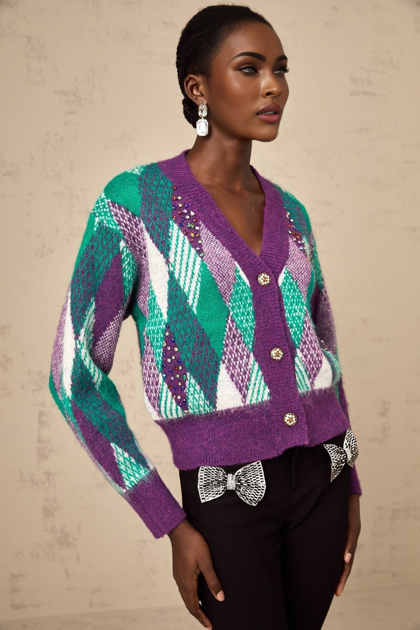 Woman wearing a purple knit top with argyle pattern design