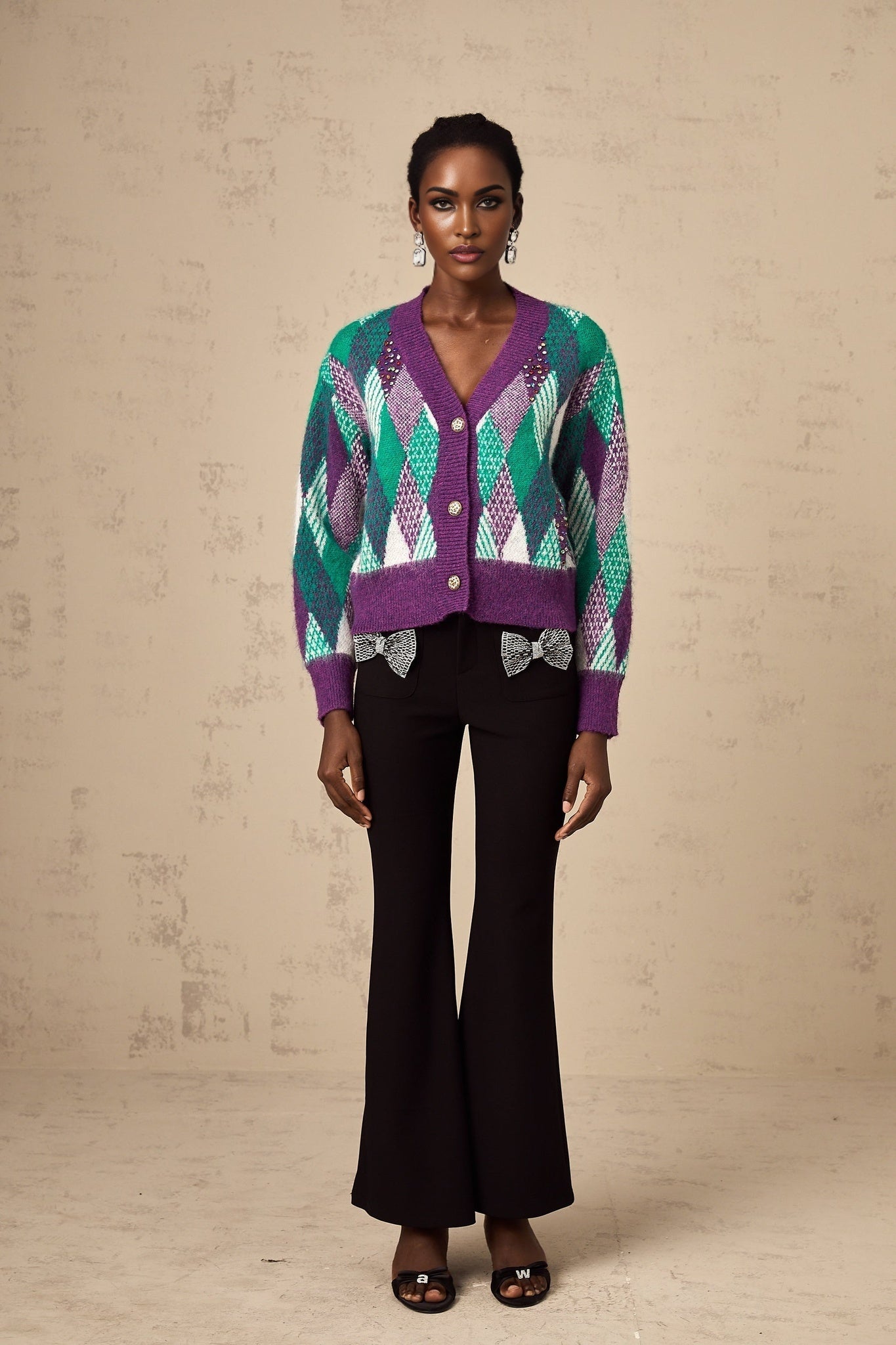 Woman wearing a purple knit top with argyle pattern