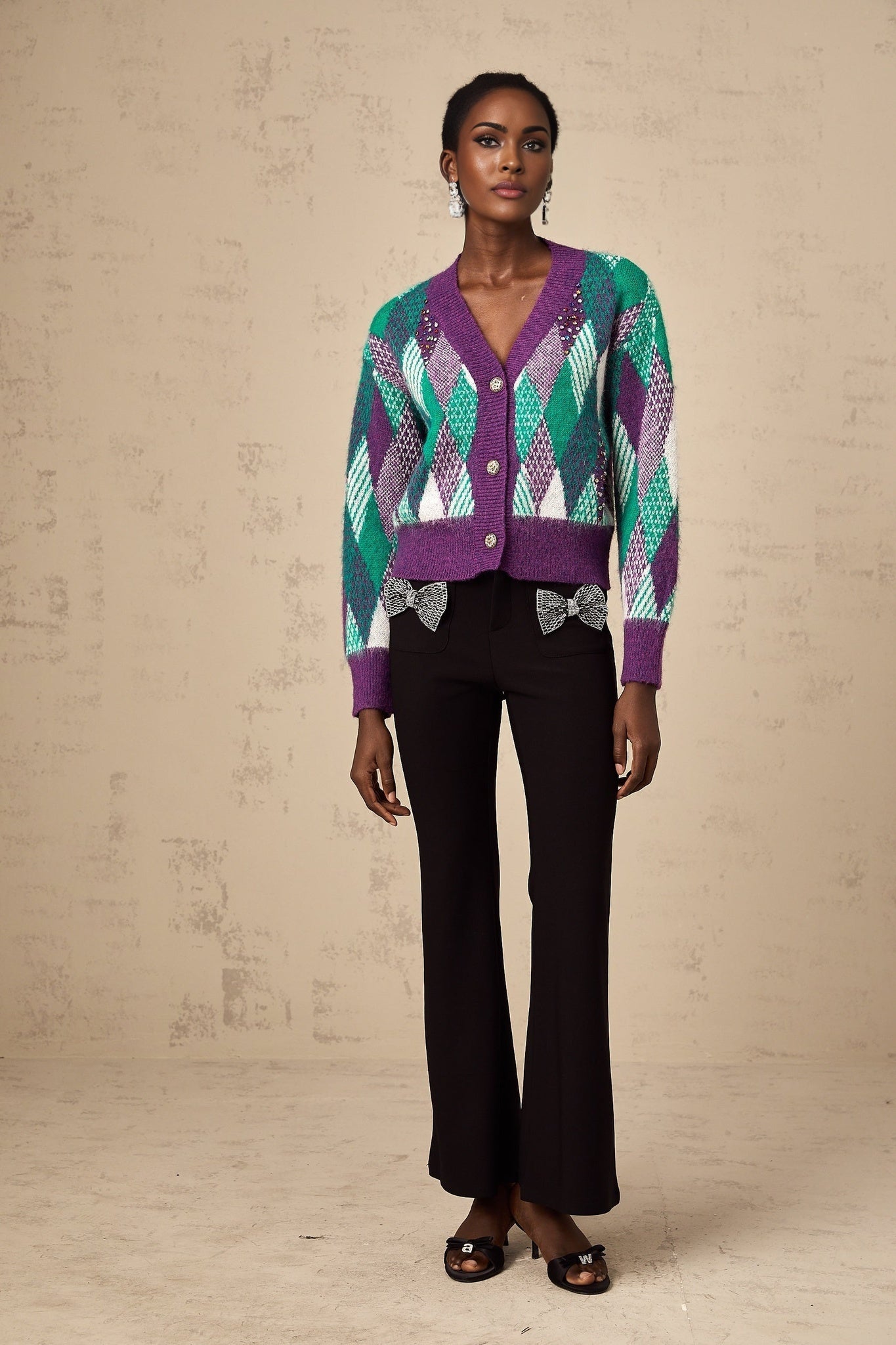 Woman wearing a purple knit top with argyle pattern