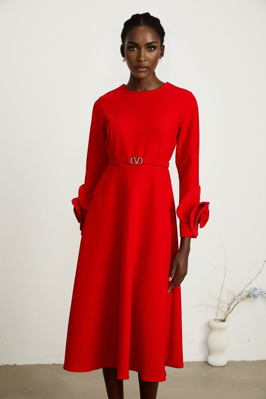 Woman wearing a red long sleeve dress with floral pattern from Aurelia collection