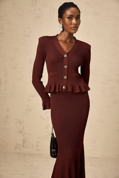 Woman wearing a red matching set with ruffled knit top and skirt