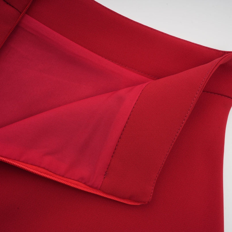 Woman wearing a red pleated blouse and matching skirt set Colette style outfit