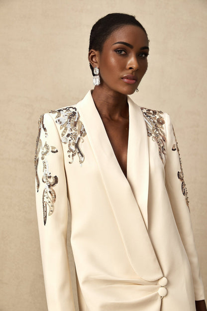 Woman wearing a shimmering blazer dress with sequin embellishments