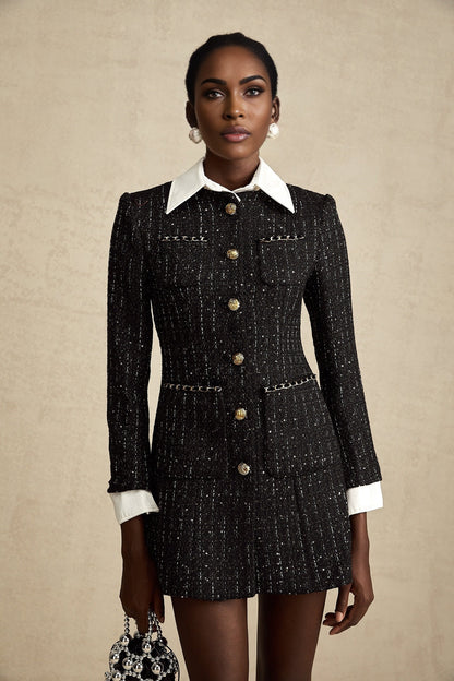 Woman wearing a short black dress with tweed fabric and sequin panels Audrey style mini dress with a mix of textures