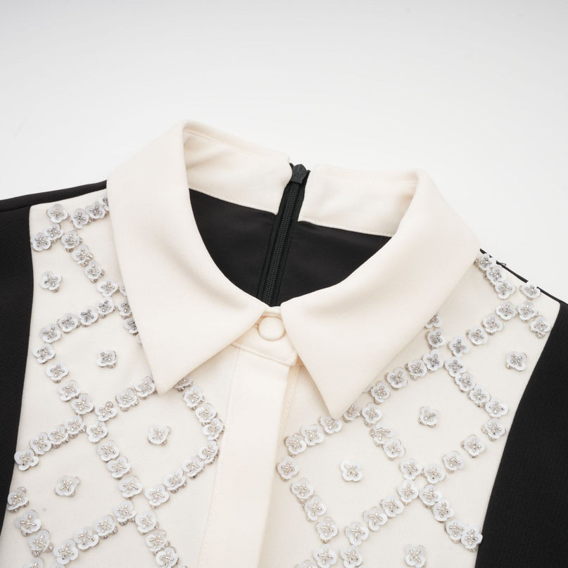 Woman wearing a short mini dress with contrasting colors and embellishments