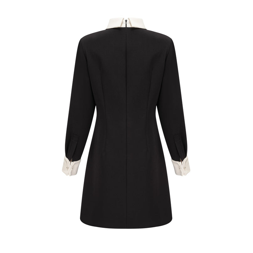 Woman wearing a short mini dress with contrasting colors and embellishments