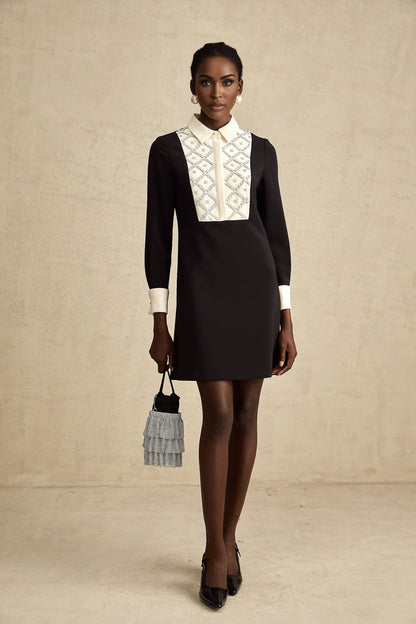 Woman wearing a short mini dress with contrasting colors and embellishments