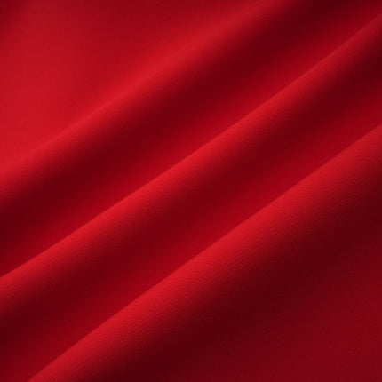 Woman wearing a short red dress with cap sleeves