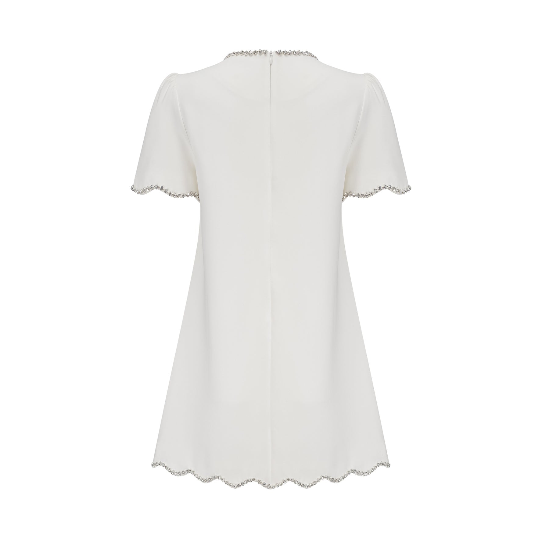 Woman wearing a short white dress with crystal embellishments