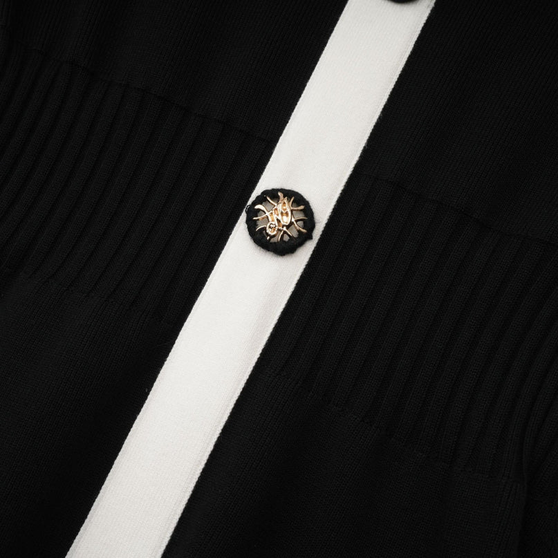 Woman wearing a short wool dress with color block design and ribbed texture in different shades