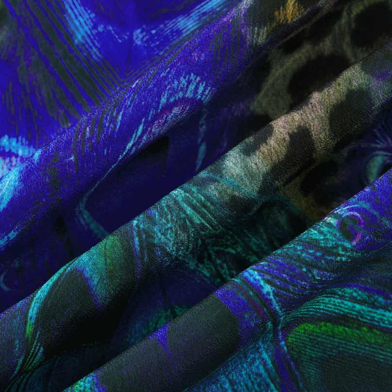 Woman wearing a silky blue sleeveless jumpsuit with halter neckline and flowing wide leg pants