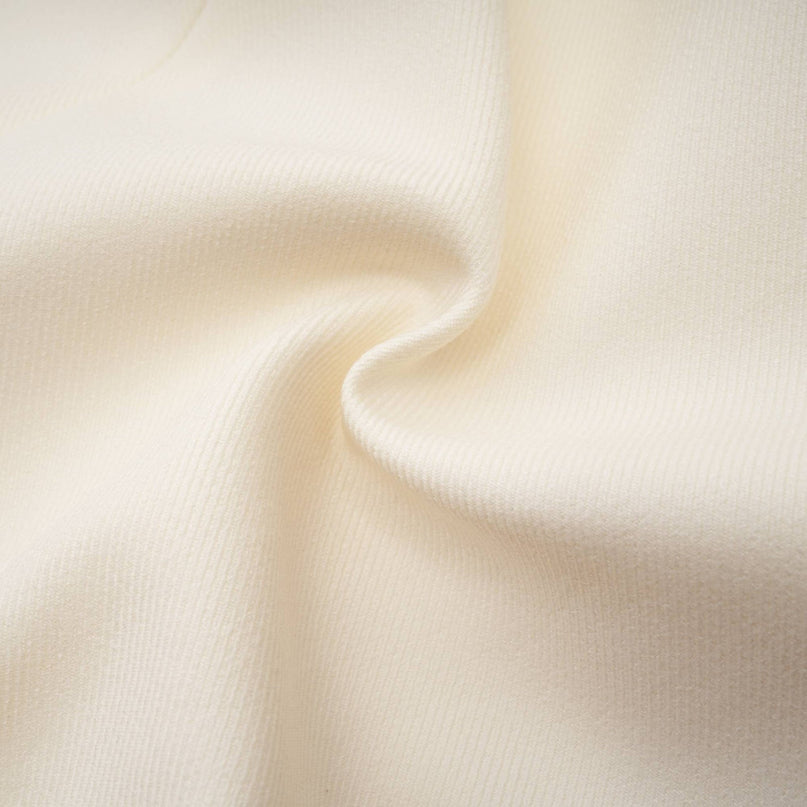 Woman wearing a sparkling jacket and matching shorts set adorned with crystal embellishments in a stylish Iselin design