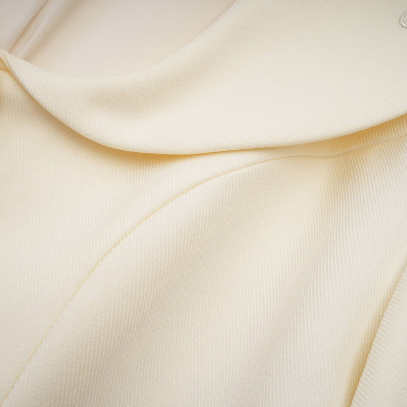 Woman wearing a sparkly jacket and matching shorts set embellished with crystals