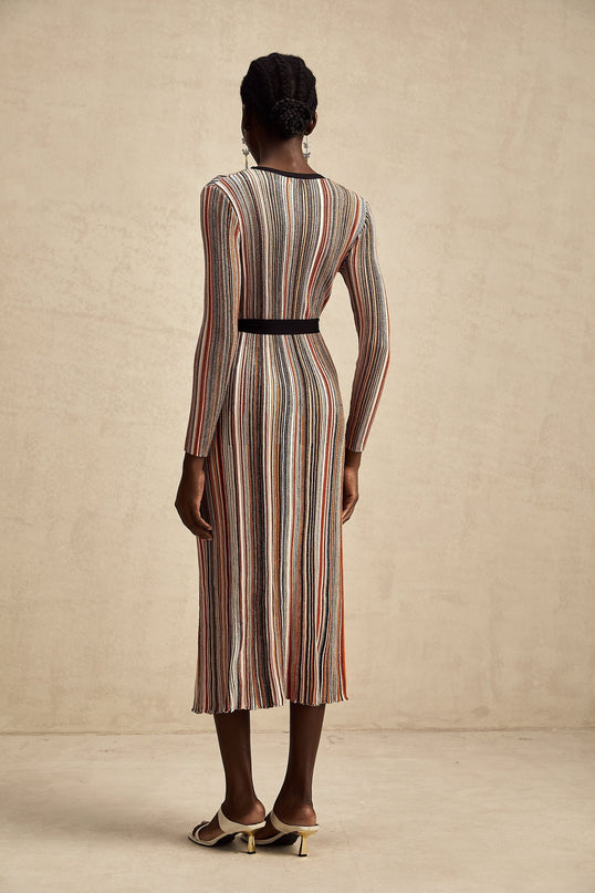 Woman wearing a striped metallic midi dress with a wrap design featuring Adele style