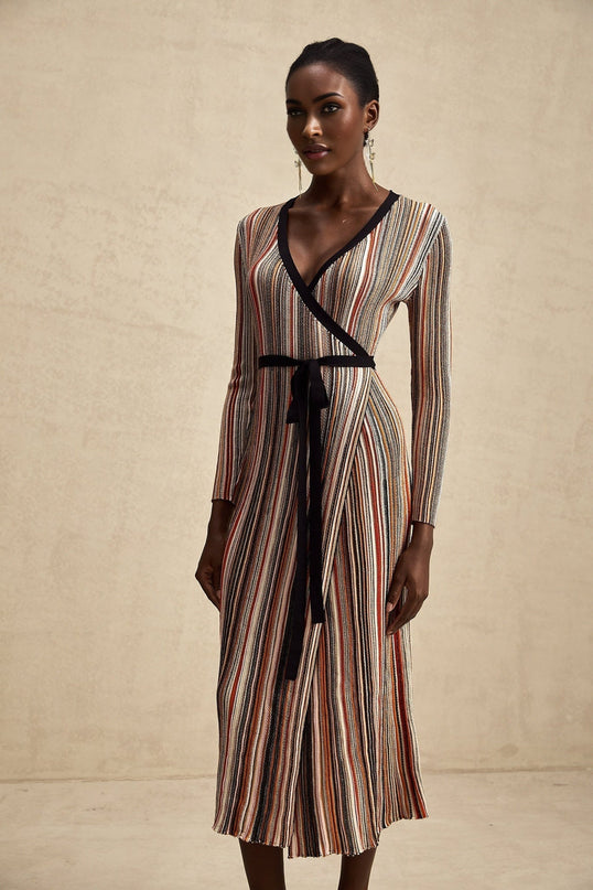 Woman wearing a striped metallic midi dress with a wrap design featuring Adele style