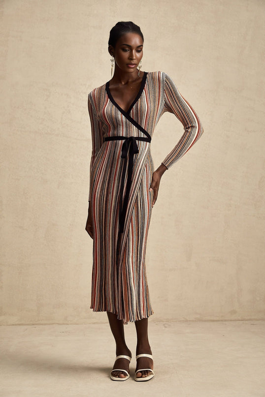 Woman wearing a striped metallic midi dress with wrap design featuring Adele style
