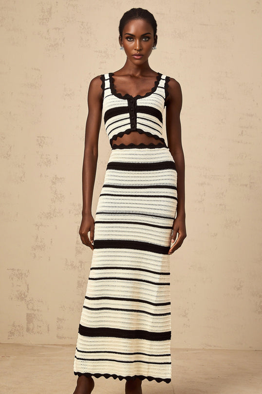 Woman wearing a striped vest top and matching skirt in contrasting colors from the Avril collection