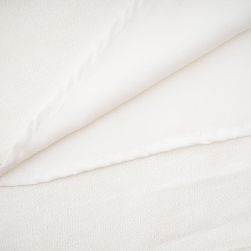 Woman wearing a white corset style midi dress with fitted bodice and flared skirt