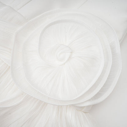 Woman wearing a white mini dress with full pleats and cinched waist detail