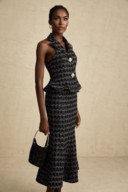 Woman wearing black and white checked tweed vest top and matching skirt set named Axelle