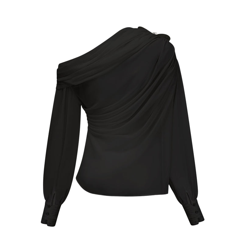 Woman wearing black asymmetric tulle blouse and matching skirt set named Andrea