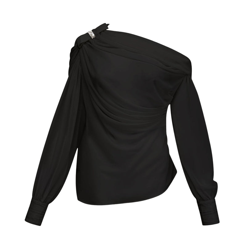 Woman wearing black asymmetric tulle blouse and matching skirt set