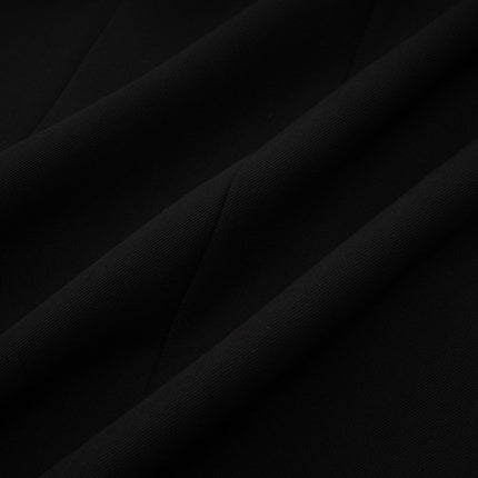 Woman wearing black blazer dress with single button closure and notched lapels