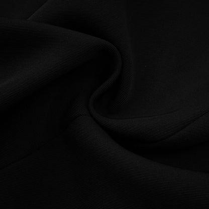Woman wearing black blazer dress with single button closure and tailored fit