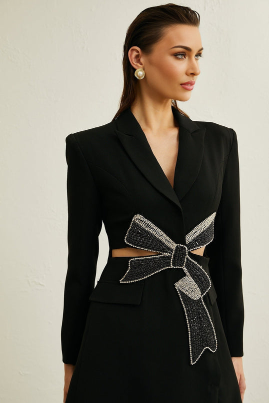 Woman wearing black blazer with bowknot detail and cutout design