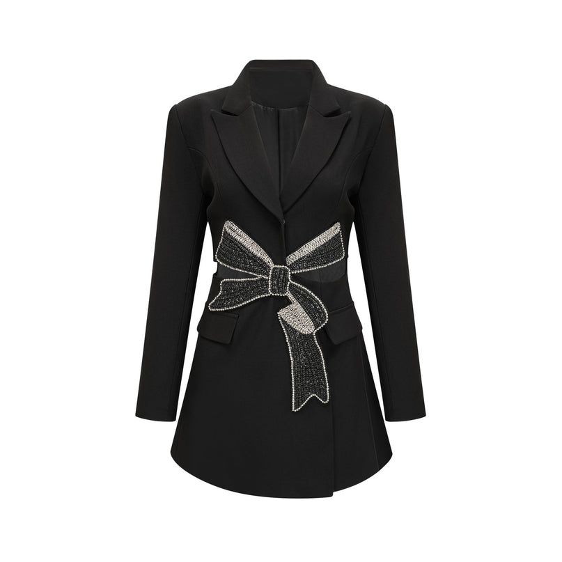 Woman wearing black blazer with bowknot detail and cutout design
