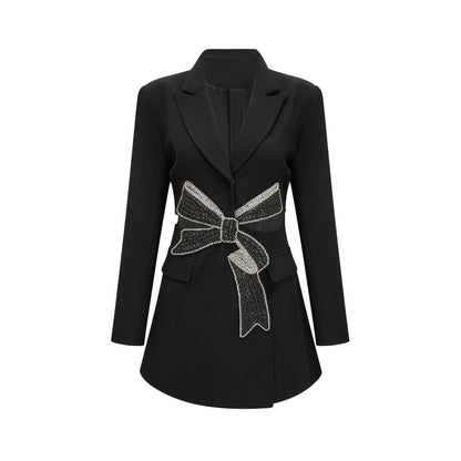 Woman wearing black blazer with bowknot detail and cutout design